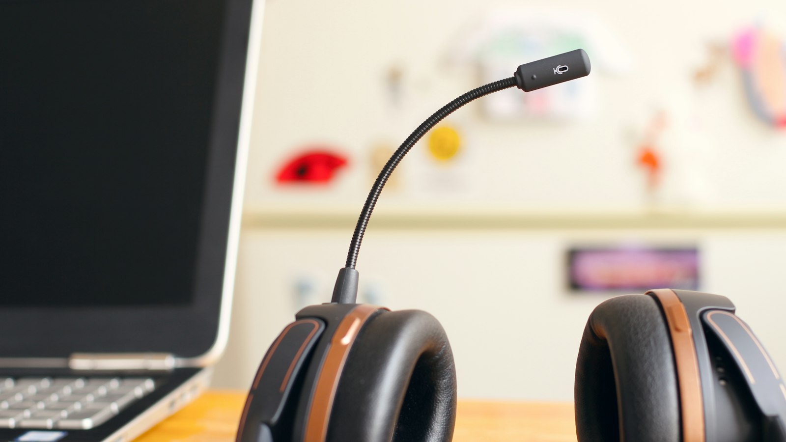 Black and brown headset near laptop computer